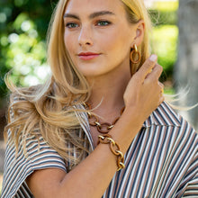 Load image into Gallery viewer, person wearing teak and gold bracelet, necklace, and earrings
