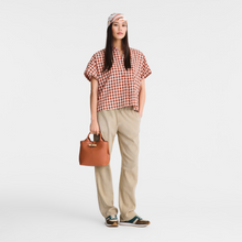 Load image into Gallery viewer, person holding small handbag