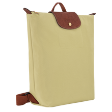 Load image into Gallery viewer, Longchamp Le Pliage Original Backpack - Medium in pale green Pistachio with brown leather straps and center flap and gold snaps and zipper pull side view to show width