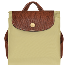 Load image into Gallery viewer, Longchamp Le Pliage Original Backpack - Medium in pale green Pistachio folded and snapped closed for travel
