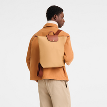 Load image into Gallery viewer, person wearing the Longchamp Le Pliage Original Backpack in fawn with brown leather trimming