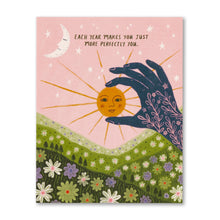 Load image into Gallery viewer, card with a hand holding the sun, text reads each year makes you just more perfectly you