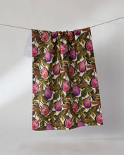 Load image into Gallery viewer, Geometry Wild Fig Tea Towel handing from twine with a stack of clean dishes next to it