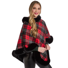Load image into Gallery viewer, person wearing Plaid Poncho with black trim along hem and neckline