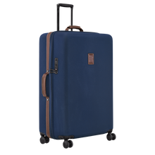 Load image into Gallery viewer, Longchamp Boxford Suitcase Embossed Style xl blue side view showing leather handle and a leather accent along the zipper of the case
