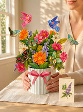 Load image into Gallery viewer, person putting a FreshCut Paper Enchanted Garden on a table