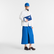 Load image into Gallery viewer, person holding Longchamp Le Pliage Collection Canvas Pouch in color Atlantic blue