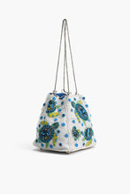 Load image into Gallery viewer, Marine Terrain Bucket Bag heavily beaded with teal, blue, and green sea turtles showing the width and silver chain straps