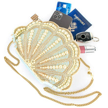 Load image into Gallery viewer, scalloped sea shell shaped hand bag with a collection of items, passport, phone, cards, key fob and lipstick