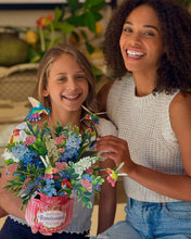 Load image into Gallery viewer, adult and child holding the FreshCut Paper Hummingbird Oasis Pop-Up Greeting Card