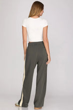 Load image into Gallery viewer, woman wearing charcoal pants with a cream colored accents along the side back view showing a pocket