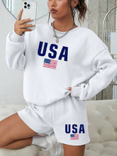 Load image into Gallery viewer, person taking a selfie while wearing two-piece set featuring a white long sleeve crewneck sweatshirt and matching white shorts.