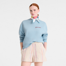 Load image into Gallery viewer, person with Longchamp La Vague du Style Silk Scarf 70 tied around their neck