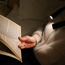 Load image into Gallery viewer, person using the Hands-Free Book Light to read in bed
