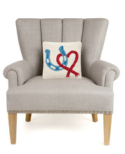 Load image into Gallery viewer, Horseshoe Heart Hook Pillow with red heart and blue horse shoe on a chair