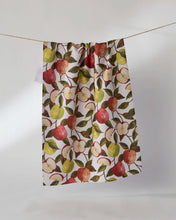 Load image into Gallery viewer, Geometry Honeycrisp Tea Towel handing from twine with a stack of clean dishes next to it