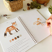 Load image into Gallery viewer, Woodland Watercolor Workbook with person painting a fox