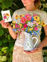 Load image into Gallery viewer, person hold the FreshCut Paper Wildflower Meadow and a matching card