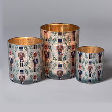 Load image into Gallery viewer, three sizes of Nutcracker Tealight Candleholders with. gold interior