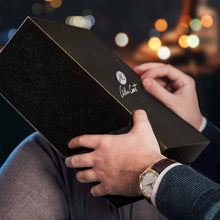 Load image into Gallery viewer, man's hands holding a black Arthur Court branded box