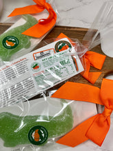 Load image into Gallery viewer, green gummy candy in packaging on a cutting board