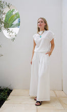 Load image into Gallery viewer, woman in the Hayley Linen Pants in white paired with a white sleeveless top