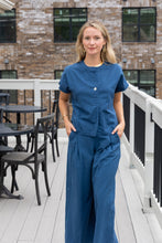 Load image into Gallery viewer, woman in the Hayley Linen Pants in blue paired with a matching top