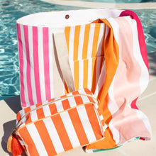 Load image into Gallery viewer, Megan Striped Cosmetic Bag and a similar tote bag sitting at the side of a pool