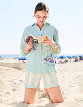 Load image into Gallery viewer, woman reading a book on the beach while wearing the Aida Buttonfront Shirt Tideglass