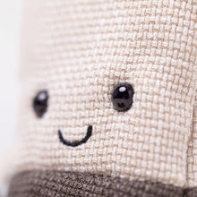 Load image into Gallery viewer, Close-up of Jellycat Amuseables Steepy Tea Bag plush showing cream woven fabric, shiny black eyes, and stitched smile.