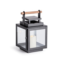Load image into Gallery viewer, black metal lantern with glass sides and wood handle on the top of the lantern