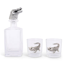 Load image into Gallery viewer, Square glass decanter with silver colored alligator head bottle stopper and two short glasses with silver colored alligator motifs on the side of the glasses