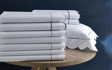 Load image into Gallery viewer, a stack of Matouk Butterfield flat sheets in available colors