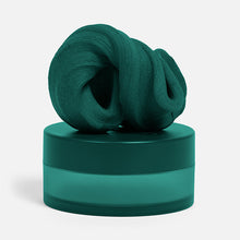 Load image into Gallery viewer, Speks Blur Calming Focus Putty in dark green sitting on its storage container