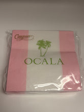 Load image into Gallery viewer, A pack of pink and white striped paper napkins with green palm tree graphics and the text 'OCALA' and 'Caspari' printed on them, sealed in clear plastic packaging.