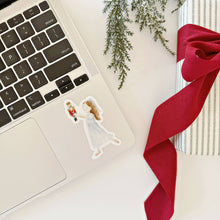 Load image into Gallery viewer, watercolor style sticker of Clara holding the nutcracker on a computer