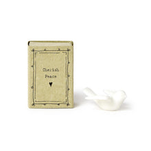 Load image into Gallery viewer, white ceramic dove next to tan box with simple line designs and the text Cherish Peace