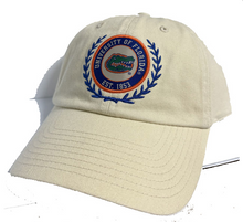 Load image into Gallery viewer, A cream-colored cotton baseball cap featuring an embroidered University of Florida logo patch on the front, set against a plain white background.