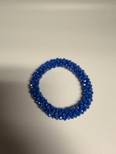 Load image into Gallery viewer, Blue beaded bracelet on a beige background