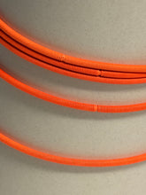 Load image into Gallery viewer, Three coiled orange cables on a light gray background