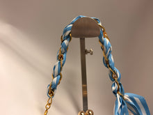 Load image into Gallery viewer, Blue and white striped hair tie with gold chain on a brown stand against a beige background