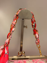 Load image into Gallery viewer, Bracelet with a red and gold pattern on a neutral background