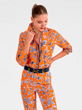 Load image into Gallery viewer, person in orange shirt and pants with blue floral design