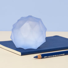Load image into Gallery viewer, blue stress ball with texture sitting on a notebook