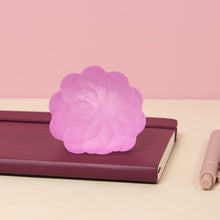 Load image into Gallery viewer, pink stress ball with texture sitting on a notebook