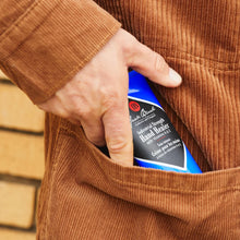 Load image into Gallery viewer, hand putting lube on Jack Black Industrial Strength Hand Healer in a pocket