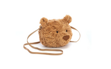 Load image into Gallery viewer, A plush teddy bear head crossbody bag in a warm brown color, featuring embroidered eyes and nose, with a matching brown strap, shown on a plain white background.