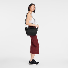 Load image into Gallery viewer, person with the Longchamp Le Pliage Energy Recycled Canvas Top Handle Bag using the longer strap