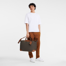 Load image into Gallery viewer, person holding a Longchamp Boxford Travel Bag Large in Brown