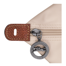 Load image into Gallery viewer, Longchamp Le Pliage Original X-Large Travel Bag in paper close up of zipper pull with Longchamp logo